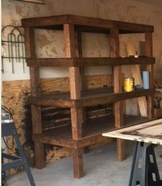 a wooden shelf sitting in the middle of a room next to a table and chairs