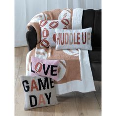 two throw pillows with footballs on them and love game day written across the pillow