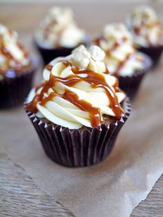 cupcakes with caramel and white chocolate drizzled on the top