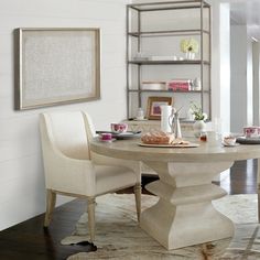 a dining room table with two chairs around it