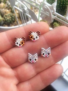 three small pixel animals are in the palm of someone's hand