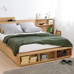 a bed sitting in the middle of a bedroom next to a book shelf filled with books