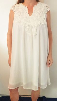 SMYS WHITE EMBROIDERED YOKE CHIFFON LAYER OVER POLYESTER LINING DRESS 2X NWOT  THIS DRESS IS BEAUTIFUL.   IT LOOKS AND FEELS GREAT NOTICE HOW FIGURE FLATTERING IT IS   UNDERARM TO UNDERARM: 24 INCHES WAIST: to 48 INCHES  LENGTH FROM BACK TO HEM: 36 INCHES  This is an anonymous auction. Only you will know you have bid.  Please feel free to ask any questions. I combine shipping. Fast shipping! I try to ship the same day I receive payment.  Please note that shipping is high due to the weight of the garment.   1970 SMYS    Exported By ExportYourStore :) White Sleeveless Mini Dress With Lace Top, White Chiffon Mini Dress For Wedding, Flowy White Dress With Lace Bodice, Flowy Lace Work Dresses, White Chiffon Mini Dress For Daywear, White Sheer Mini Dress For Daywear, White Chiffon Dress With Lace Trim, Tampa Fl, Dress Clothes For Women