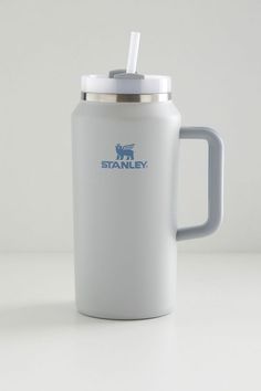 a stainless steel travel mug with a straw in the cup and stanley logo on it