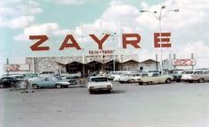 cars are parked in front of a building with the word zayrre on it