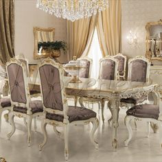 a dining room table with chairs and a chandelier