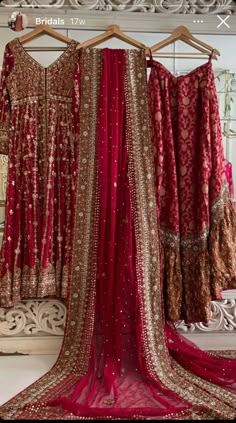 red and gold wedding dress hanging on a rack