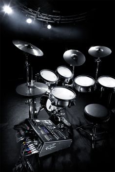 a black and white photo of a drum set