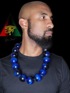 This handsome and eye catching piece is hand crafted and created by Eye Create LLC.  This item is stained in a beautiful custom made deep and vibrant royal blue. All stains are made by our company. All beads are solid and hand drilled by yours truly. These beads are highly glossed and stands out like no other!  The necklace can be purchased individually or as a set with the matching bracelet.   The bracelet is made from natural Blue Tiger eye, Black Obsidian, and Hematite gem beads.    Please fo Blue Wooden Beads Round Jewelry, Blue Wooden Round Beads Jewelry, Blue Wooden Beaded Round Jewelry, Blue Wooden Beads Jewelry For Healing, Blue Spiritual Necklaces With Large Beads, Unique Blue Wooden Beads, Spiritual Blue Necklaces With Large Beads, Healing Blue Wooden Beads Jewelry, Artisan Blue Wooden Beads