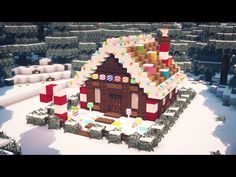 a large gingerbread house in the middle of a snowy landscape