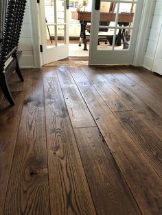 a wooden floor in front of a white door