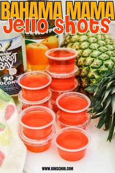 there are many jars of jello shots next to pineapples