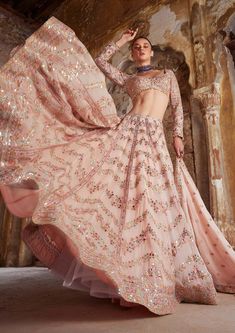 Editor's Note The peach georgette lehenga set with chevron design embroidery in foil, resham, mirror, and gota is a perfect blend of traditional and modern. The full-sleeved embroidered blouse adds an elegant touch, and the matching dupatta completes the look. Fabric: Georgette, lining: crepe lining Color: Peach Components: Lehenga, blouse and dupatta Occasion: Sangeet and wedding Disclaimer: Product color may slightly vary due to photographic lighting sources or your monitor setting. Care: Dry Glam Lehenga, Full Sleeve Lehenga, Peplum Sharara, Seema Gujral, Ridhi Mehra, Gold Lehenga, Chevron Mirror, Raw Silk Lehenga, Full Sleeve Blouse