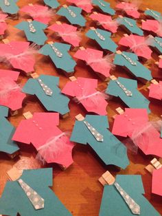 several pieces of paper with bows on them sitting on a wooden table next to each other