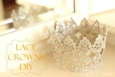 a silver crown sitting on top of a white counter next to a mirror with the words lace crowns diy written across it