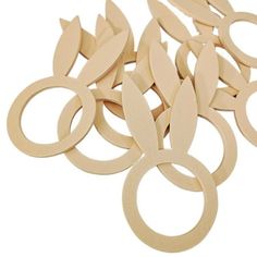 wooden circles and rings with leaves cut out on the top, all in different sizes