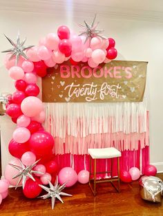 balloons and streamers are on the floor in front of a sign that says brooke's twenty west