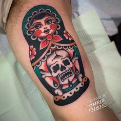 a person with a tattoo on their arm and skull in the middle of his arm