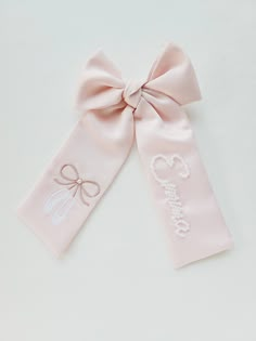 Light pink satin bow with ballerina shoes and name in pearls beaded by hand. Length: 9 inches Satin Products, Elegant Pink Bow With Ribbon, Pink Bow Nursery Theme, Baby Girl Pink Bow Nursery, Pink Bow Embroidery, Personalized Bow, Little Ballerina, Ballerina Birthday