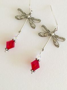 "Beautiful antique silver filigree dragonfly earrings featuring lovely large 8mm Siam red Swarovski Crystal and 4mm clear Swarovski Crystal AB. Silver dragonfly charms are 24 x 24mm and hang from Sterling silver ear wires. Total length is 2\". Lightweight and beautiful red crystal earrings! Available on Sterling silver ear wires or silver plated wires." Elegant Hypoallergenic Dragonfly Earrings, Elegant Dragonfly Earrings With Ear Wire, Elegant Dragonfly Jewelry With Ear Wire, Trendy Jewelry Ideas, Paris Charm Bracelet, Dragonfly Charm, Dragonfly Earrings, Button Jewelry, Earrings Red