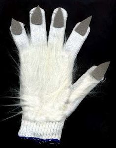 a pair of white gloves with long, furry fingers on top of each glove is shown in front of a black background