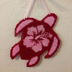 a red and white teddy bear hanging on a wall