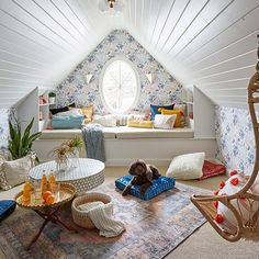 a dog sitting on a cushion in the middle of a room with a window seat