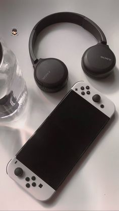 a nintendo wii game controller and headphones on a table