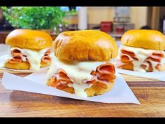 two sandwiches with ham and cheese on them