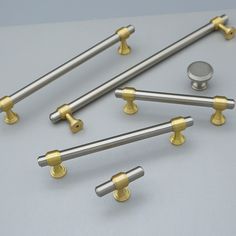 several metal handles and knobs on a gray surface