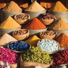 an assortment of colorful spices and herbs for sale at a market stall - stock photo