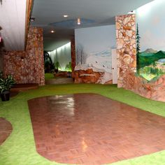 a large room with paintings on the walls and flooring in front of a wall