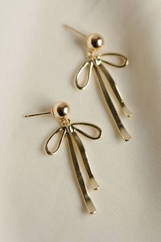 Rumor has is that 2024 is the year of BOWS! These super cute, dangly bow earrings will be the HIT of any party. Includes two gold or silver-plated dangly bow charms 6mm 14k gold-filled or sterling silver, hypoallergenic ball studs Choose from either solid or sparkly Gold Dainty Bow Earrings, Gold Dainty Earrings With Bow, Dainty Gold Earrings With Bow, Adjustable Gold Earrings With Dangling Charms, Cute Earrings With Dangling Charms For Gifts, Gold Plated Bow Jewelry Gift, Gold Dangle Jewelry With Bow, Gold Earrings With Dangling Charms, Gold Plated Bow Jewelry For Gift