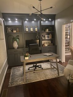 a living room filled with furniture and a wooden table in front of a book shelf