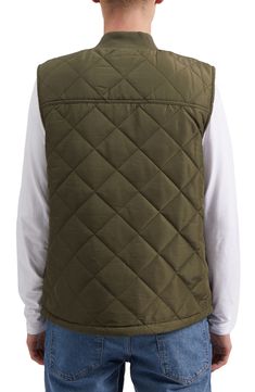 Cozy faux shearling lines the interior of this diamond-quilted puffer vest finished with spacious pockets. 28 1/2" length (size M) Blade collar Sleeveless Front zip closure Split kangaroo pocket 100% polyester faux-shearling lining 100% polyester Machine wash, tumble dry Imported Model stats: 6'0" height; 32" waist. Model is wearing size M. Quilted Vest For Cold Weather, Winter Utility Nylon Vest, Quilted Functional Winter Vest, Quilted Nylon Vest For Cold Weather, Functional Quilted Nylon Vest, Outdoor Sleeveless Quilted Vest, Quilted Puffer Vest, Concert Looks, Designer Crossbody Bags