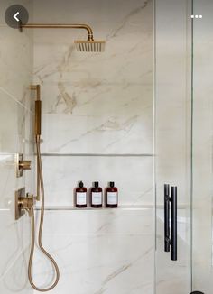 a bathroom with marble walls and shower head