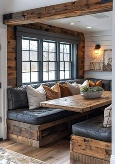 a living room filled with lots of furniture and wooden beams on the wall above it