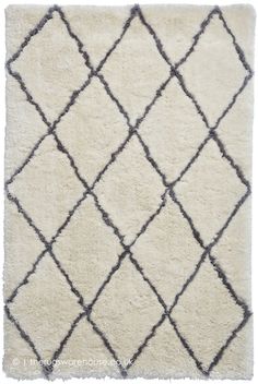 a rug with black and white designs on the bottom, in front of a white background