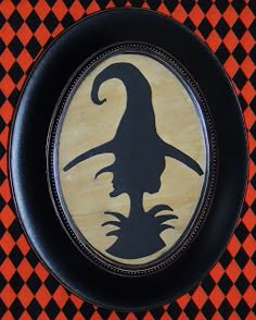 a black and orange plate with a witch's hat on it