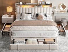 a white bed with drawers underneath it in a small room next to a dresser and mirror