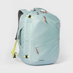 a light blue backpack with yellow straps on the front and back ends, sitting against a white background