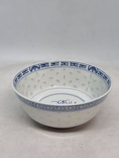 a blue and white bowl sitting on top of a table