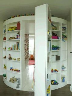 two white shelves filled with toys in a room