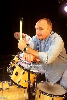 a man is playing drums on stage