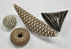 three ceramic objects including a banana, donut and zebra print design on white paper