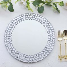 a white plate topped with silverware next to a fork and knife on top of a table