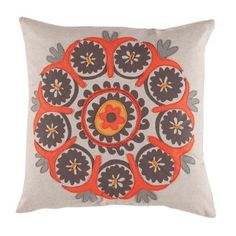 a decorative pillow with an orange and grey flower design on the front, sitting on a white background