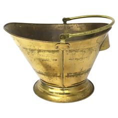 an old brass bucket with handles on a white background