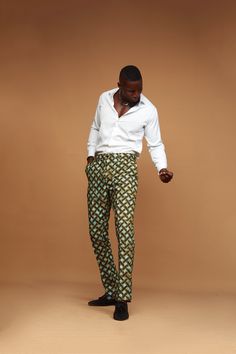 Zanaani's classic trousers are designed from durable cotton or poly-cotton in a slimfit silhouette. Crafted in African print they're detailed with abstract prints, side pockets and belt loops. Achieve a more casual look by teaming with white sneakers or a professional look by pairing with your favorite white shirt or blazer jacket. PRODUCT DETAILS -Button and concealed zip fastening at front -Composition:Poly-cotton -Dry clean or machine wash with like colors -Slimfit Fit  -Belt Loop -Fixed waistband -Side pocket SIZE GUIDE Size :      S                  M                     L                   XL                 2XL                    3XL                                                                              Waist:     32                35                   38                   41 Fitted Green Chinos, Fitted Traditional Trousers, Traditional Fitted Full-length Pants, Fitted Full-length Traditional Pants, Traditional Green Straight Pants, Traditional Fitted Green Bottoms, Fitted Traditional Green Bottoms, Traditional Fitted Green Pants, Fitted Green Traditional Pants