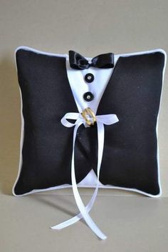 a black and white pillow with a tuxedo on it